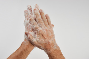 Man washing dirty hands with soap, close-up