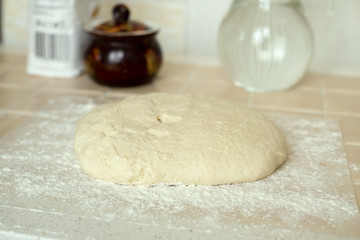 Knead the dough on the kitchen table.