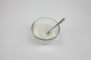 Sugar in a small cup on a white background
