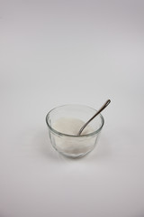 Sugar in a small cup on a white background
