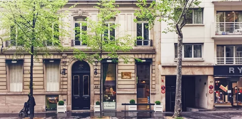 Foto op Plexiglas Paris, France circa January, 2020: Parisian architecture and historical buildings, restaurants and boutique stores on streets of Paris, France © Anneleven