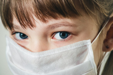 close-up of a child in a medical mask