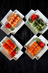 Sushi, Asian food, rolls, Philadelphia, sesame. Restaurant food. Fast food. Sushi set, set lunch. On a black background.