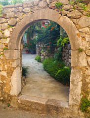 Arch of stone in entrance to the gardens in Croatia