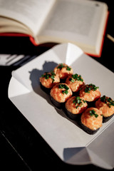 Sushi, Asian food, rolls, Philadelphia, sesame. Restaurant food. Fast food. With books, study, glasses for sight.