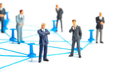 Business connection. Communication between businessmen. Network of threads and office pins. Isolated on  white background