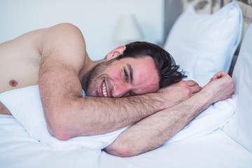 Handsome male in bed chilling and having nice moments in the morning