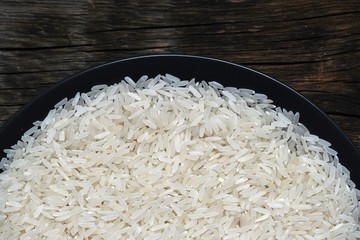 White rice in a plate on a wooden background. Healthy diet.