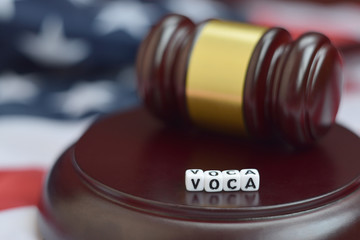 Justice mallet and VOCA acronym. Victims of crime act