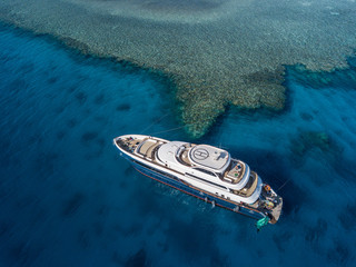 Aerial view: on Red sea, boat parking close to coral reef. Egypt 