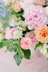 Wedding flowers, bridal decor closeup. Decoration made of peonies, roses and decorative plants