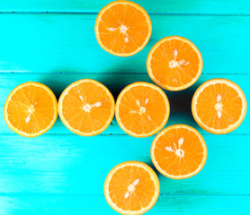 cut orange on a blue wooden background