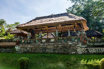 A richly decorated pavilion with thatched roof in Taman Ayun Temple, Bali, Indonesia
