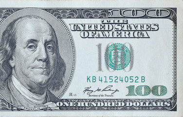 Portrait of US president Benjamin Franklin on 100 dollars banknote closeup macro fragment. United...