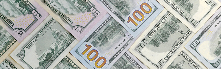 Many one hundred and fifty dollar bills on flat background surface close up. Flat lay top view