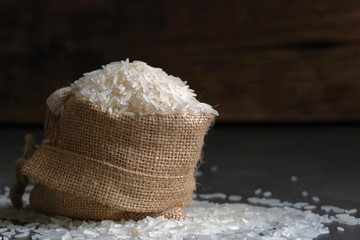 White rice in a bag made of coarse natural fabric.