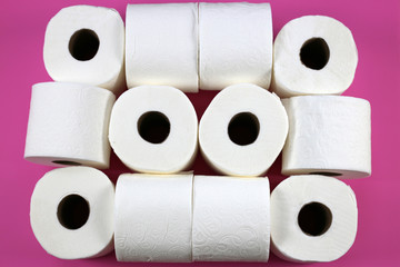 Rolls of toilet paper on a pink background