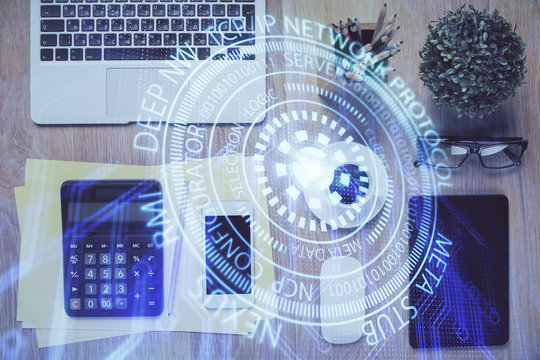 Double exposure of technology theme drawing over work table desktop. Top view. Global data analysis concept.