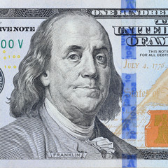Portrait of US president Benjamin Franklin on 100 dollars banknote closeup macro fragment. United...