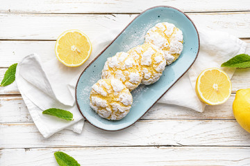 Delicious citrusy snack, crunchy lemon crinkle cookies coated with powdered sugar