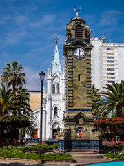 Antofagasta, Chile; May 3, 2019: Mini Big Ben and church in the Plaza Colon.