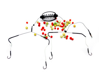 Bait Feeder and plastic bait isolated on white background. Balls for fishing. Bait for fish. Lure and cage feeder. Swim Feeder. Carp Feeder.  © serega_100500