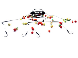 Bait Feeder and plastic bait isolated on white background. Balls for fishing. Bait for fish. Lure and cage feeder. Swim Feeder. Carp Feeder.  © serega_100500