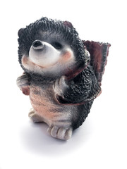 Obraz premium Piggy bank isolated on a white background. Piggy bank in the form of a hedgehog. Piggy bank and banknotes.