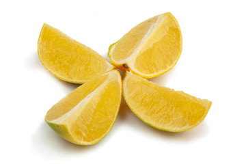 yellow grapefruit cut into four parts on a white background. Isolate
