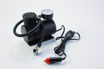 Car pump with manometer, air compressor on white background.