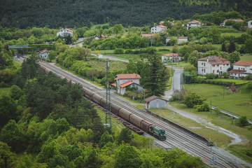 Panorama of train station in Stanjel, Slovenia, with a freight train waiting for a free path to start its journey towards Nova Gorica