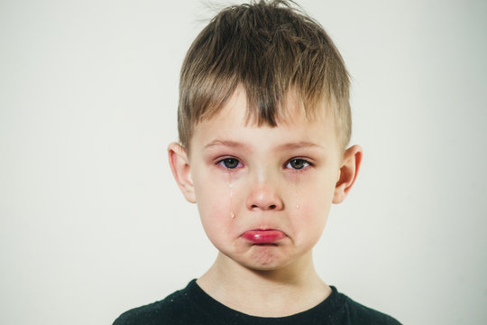 little boy with tears on his face close-up