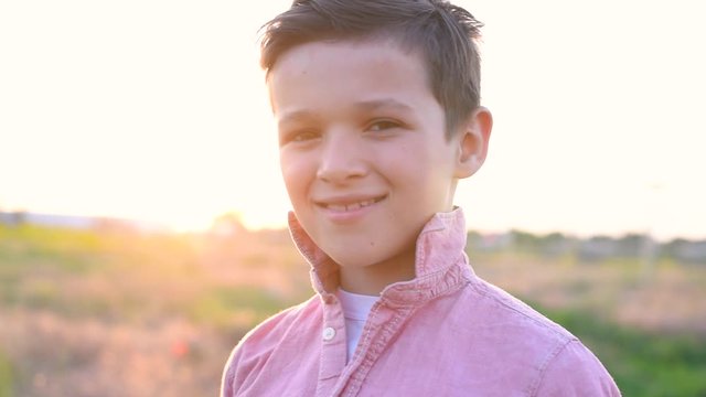 Handsome boy in siiting in field