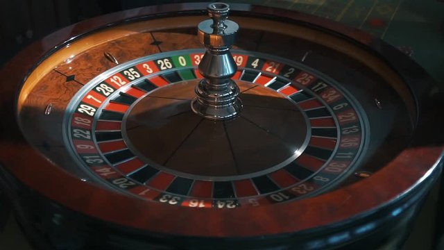 A shot of a casino roulette in motion,the ball stops at 21 red thirty six/Better luck next time