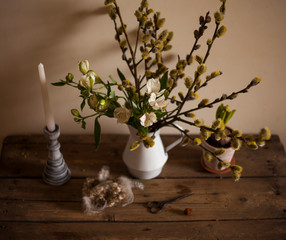spring,easter composition on the windowsill / jug  with willow branches and flowera alstroemeria,candlestick,bird nest