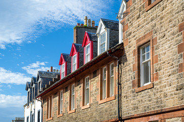Upper floor of old buildings with colorful decoration. Campbeltown old town, Scotland.