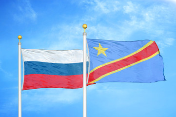 Russia and Congo Democratic Republic two two flags on flagpoles and blue sky