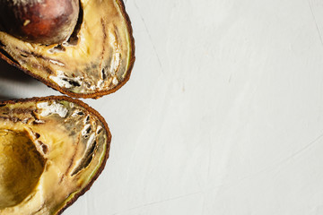 rotten avocado on a blue background