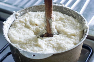 Ghomi, popular dish made of white coarse cornmeal, in big kettle.