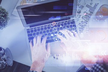 Double exposure of man's hands typing over computer keyboard and data theme hologram drawing. Top view. Technology concept.