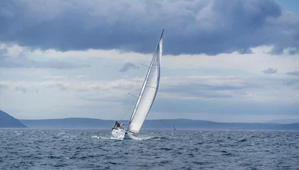 Fotobehang Sailing boat at regatta mode, full speed and good heeling angle. Near Arran island, Scotland © AlexanderNikiforov