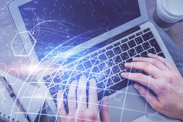 Multi exposure of man's hands typing over computer keyboard and world map hologram drawing. Top view. Technology concept.