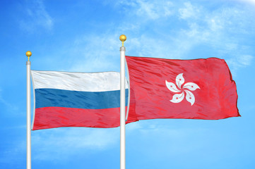 Naklejka na ściany i meble Russia and Hong Kong two flags on flagpoles and blue cloudy sky