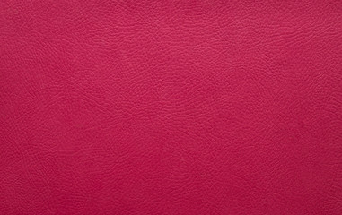 Dark pink leather background texture. The surface of the fuchsia