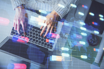 Double exposure of woman hands working on computer and data theme hologram drawing. Top View. Technology concept.