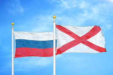 Russia and Northern Ireland two flags on flagpoles and blue cloudy sky
