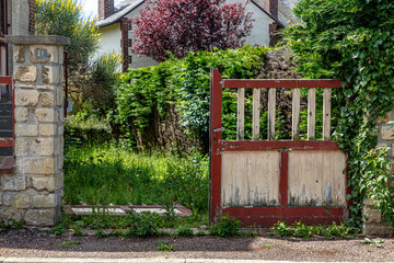 Fototapeta na wymiar Old broken wooden gates in the Park