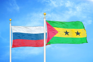 Russia and Sao Tome and Principe two flags on flagpoles and blue cloudy sky