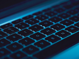 code and keyboard  blue background ethical hacking concept 