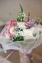 A beautiful multicolored bouquet of roses, eustomas and chrysanthemums. Soft focus.